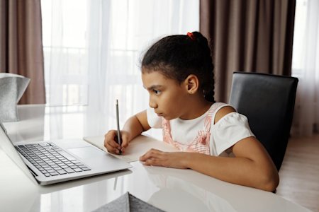 A student on her laptop at home leveraging Foxpass to connect to the school's network.