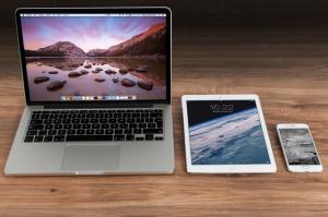 Laptop, tablet, and smartphone on a desk for remote work with Splashtop