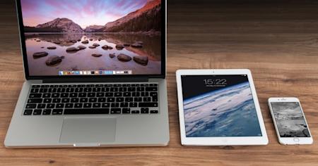 Laptop, tablet, and smartphone on a desk for remote work with Splashtop
