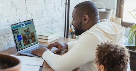 Parent and child working on a laptop at home using Splashtop