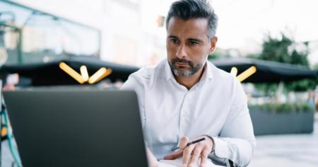 Man on computer reading why Splashtop is better than BeyondTrust