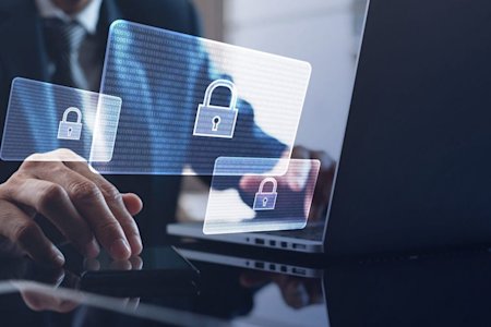 Laptop displaying AR notifications for potential cyber attacks