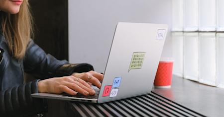 A person types on a laptop computer.