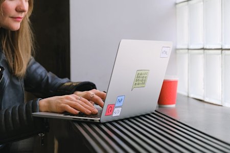 A person types on a laptop computer.