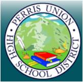 Logo of Perris Union High School District featuring mountains, books, a quill, and a lamp of knowledge in the center, with the district name written in a circular border around the image.