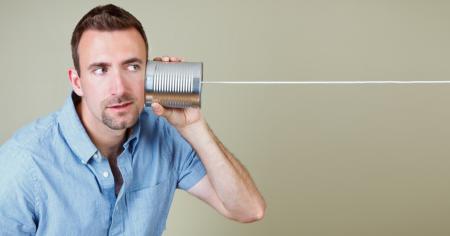 Man holding a tin can as a communication device