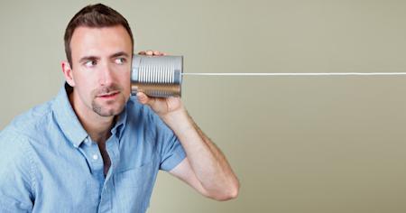 Man holding a tin can as a communication device