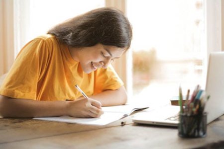 Student accessing school software in a computer lab remotely using a laptop