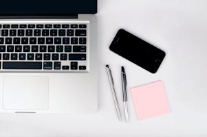 A computer and smartphone on an office desk.