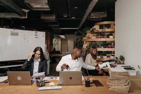 A group of people working on their computers in an office.
