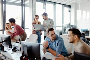 A team of IT Pros using remote management tools in the office.