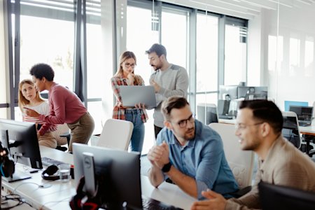 A team of IT Pros using remote management tools in the office.