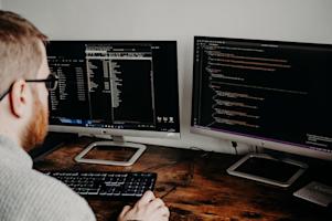 An IT worker at his workstation.
