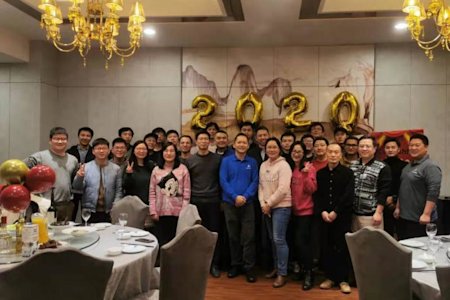 Group of Splashtop team members posing together at a festive event with balloons and '2020'