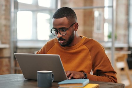 A man working on a laptop device.