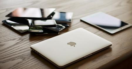 Multiple devices sitting on a desk.