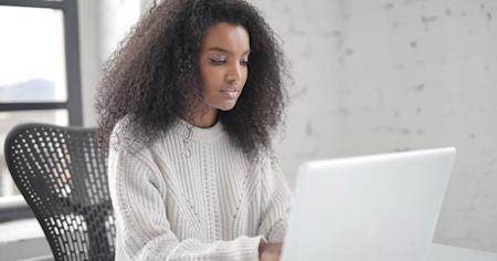 A woman using a computer.