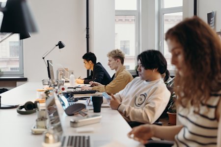 A team works on their computers in an office.