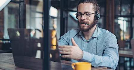 Support technician sitting at a computer, providing remote support