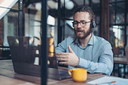 Support technician sitting at a computer, providing remote support