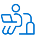 Blue icon of a person sitting and using a laptop, with a suitcase beside them, suggesting work or productivity while traveling.