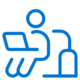Blue icon of a person sitting and using a laptop, with a suitcase beside them, suggesting work or productivity while traveling.