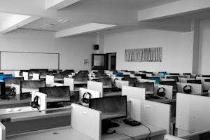 A room full of computers and office desks.