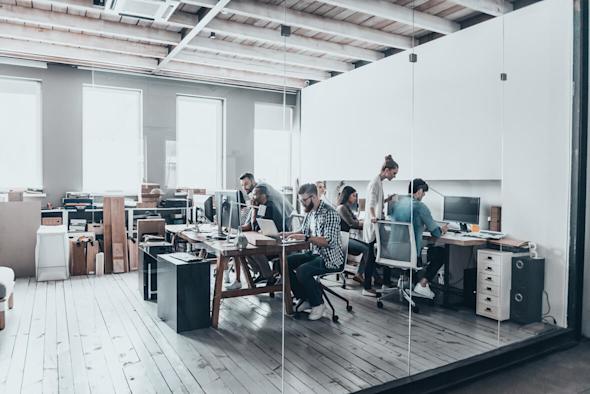 A large, sunny open space office with 6 hybrid employees.