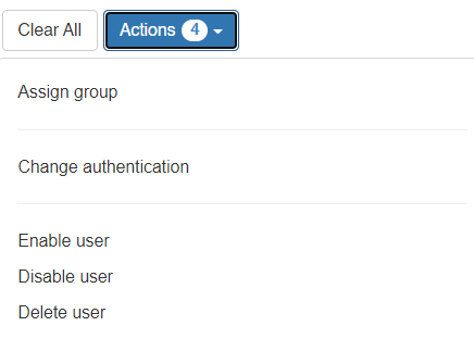 A screenshot of a user management menu with a blue Actions button showing a count of 4. Options listed are: Assign group, Change authentication, Enable user, Disable user, and Delete user. A Clear All button is also visible.