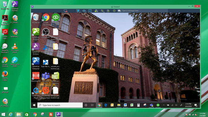 A computer desktop with various application icons and an open window showing a photo of a university campus with a statue and brick buildings. The time on the taskbar is 3:14 PM.