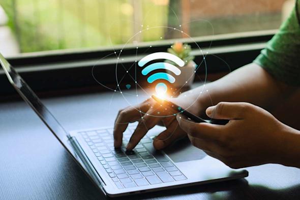 Laptop and phone accessing Wi-Fi network