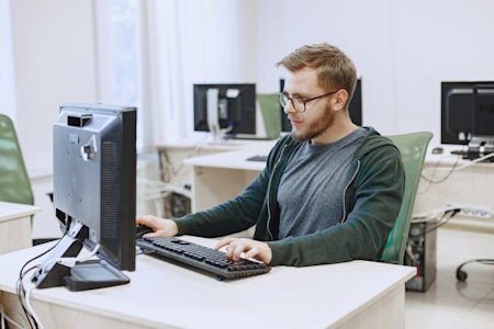 A man working at his computer in an office.