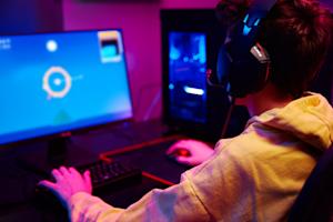 A young gamer playing video games on his home computer.