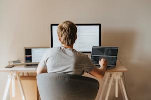 A person working remotely from home on a computer.