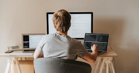 A person working remotely from home on a computer.