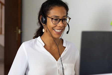 A woman comparing the pricing of LogMeIn Rescue and Splashtop SOS on her laptop