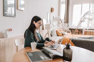 A remote employee using a laptop to work from home.