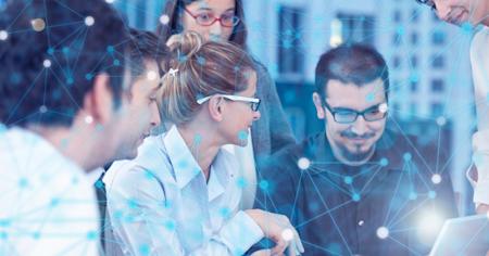 IT professionals collaborating around a laptop, with a digital network overlay representing server connectivity and cybersecurity.