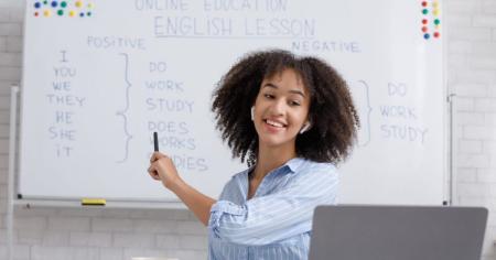 Woman writing on a whiteboard in classroom