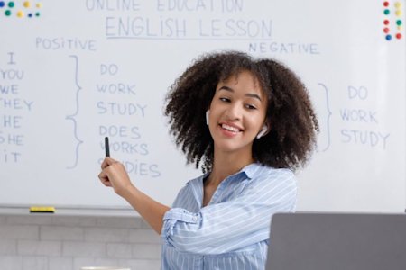Woman writing on a whiteboard in classroom