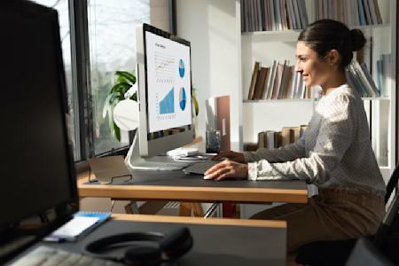 A woman using Splashtop remote desktop software on a Mac computer