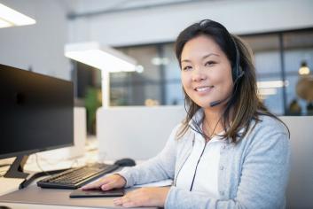 A smiling IT technician after providing remote support to a customer