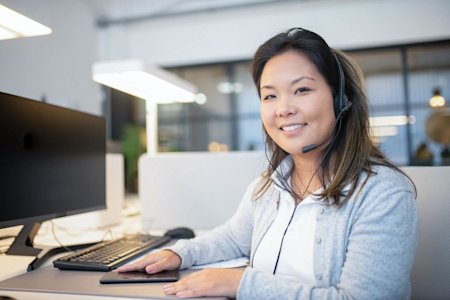 A smiling IT technician after providing remote support to a customer