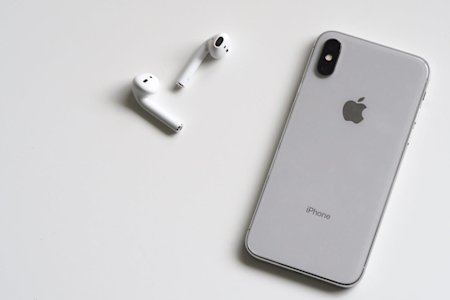 An iPhone and earbuds