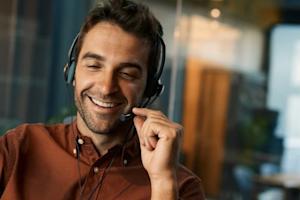 IT helpdesk professional providing remote support to a client via headset