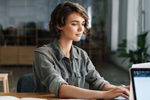 A woman using Splashtop on her laptop to remotely access her work computer to work from home.