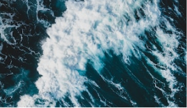Crashing waves, deep dark blue with bright aquamarine edges. 