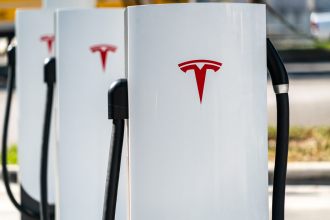 Outdoor EV charging stations branded with Tesla iconography 