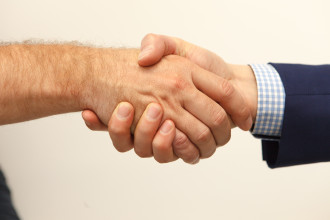 Two individuals shaking hands 