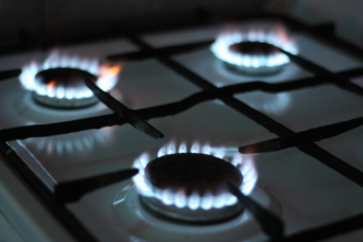Gas is lit up on a traditional gas stovetop common in many Australian properties 